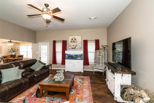 living room with ceiling fan and dark hardwood / wood-style flooring