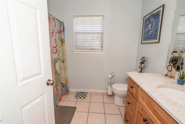 bathroom featuring toilet, vanity, and tile patterned floors