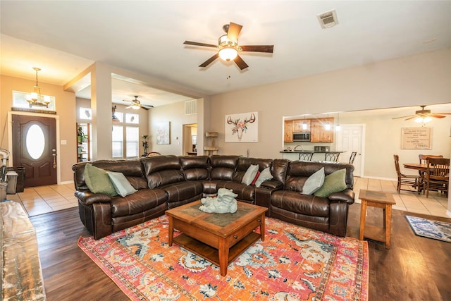 living room with hardwood / wood-style floors and ceiling fan