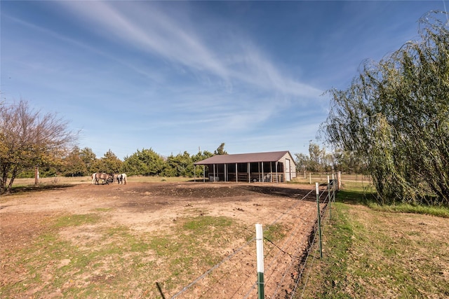 view of yard with an outbuilding and a rural view