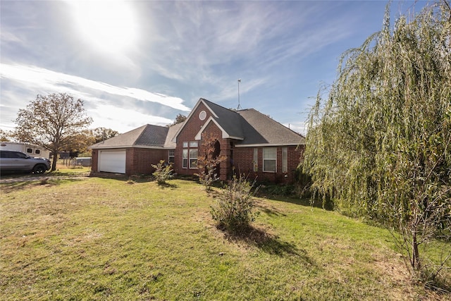 view of front of property featuring a front lawn and a garage