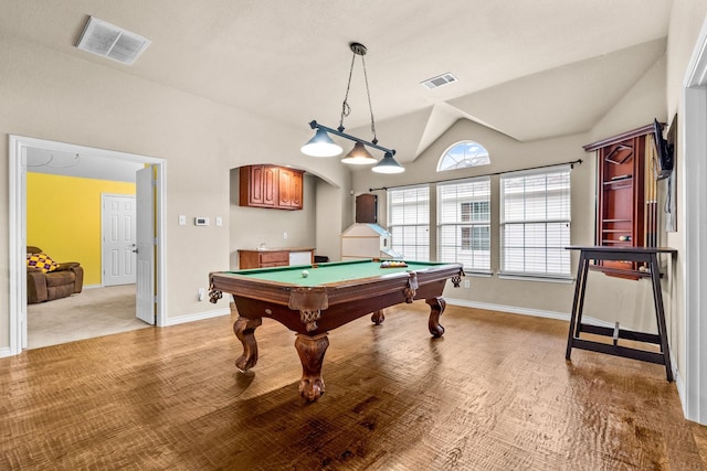 kitchen with sink, appliances with stainless steel finishes, tasteful backsplash, decorative light fixtures, and a kitchen island