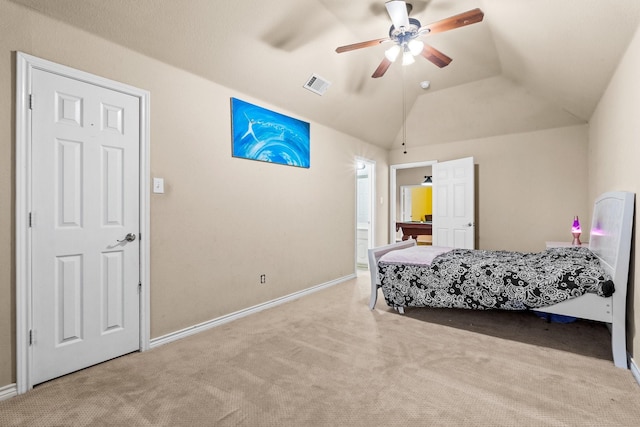 bedroom featuring vaulted ceiling, light colored carpet, and ceiling fan