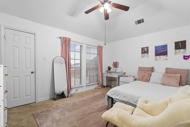 carpeted bedroom with ceiling fan and vaulted ceiling