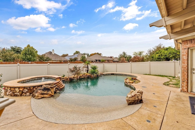 view of pool with an in ground hot tub and a patio area