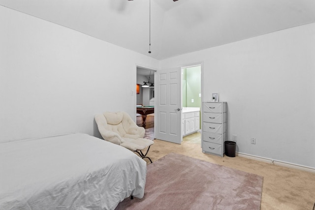 bedroom featuring light colored carpet, ensuite bathroom, and billiards