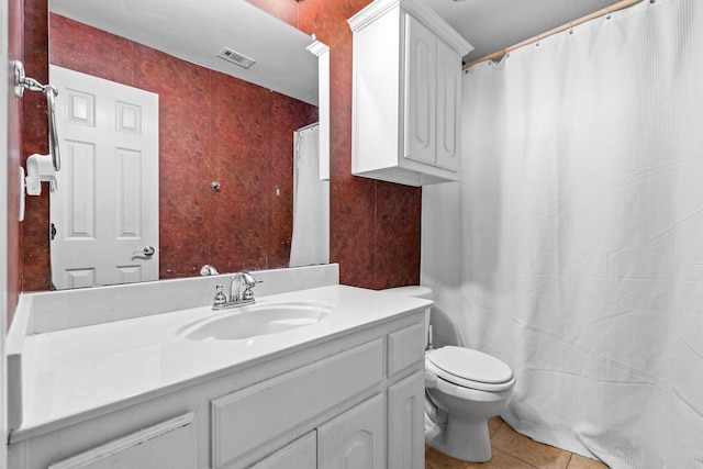 bathroom featuring vanity, tile patterned floors, and toilet