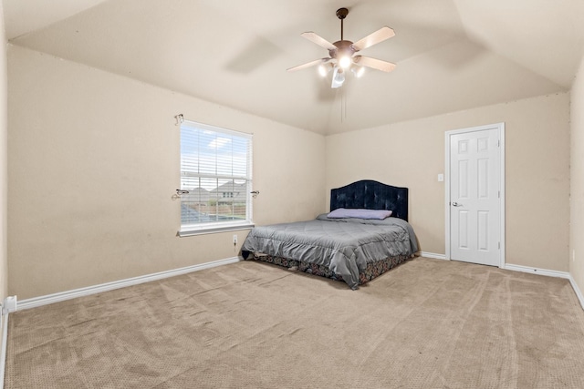 carpeted bedroom featuring lofted ceiling and ceiling fan