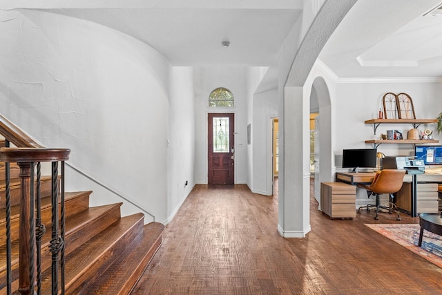 foyer with crown molding and dark hardwood / wood-style floors