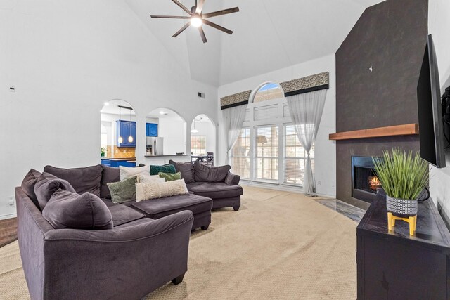 living area featuring a healthy amount of sunlight, a tray ceiling, ornamental molding, and dark wood-type flooring