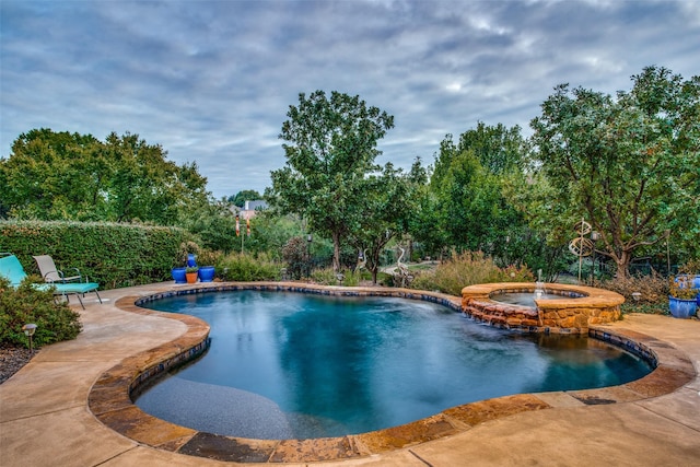 view of pool featuring an in ground hot tub and a patio area