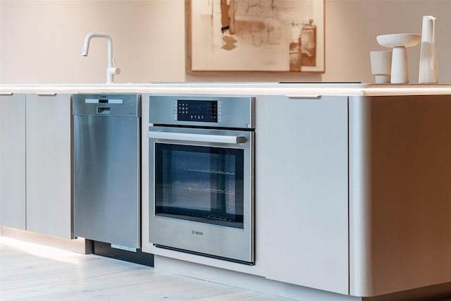 kitchen with white cabinetry and stainless steel oven