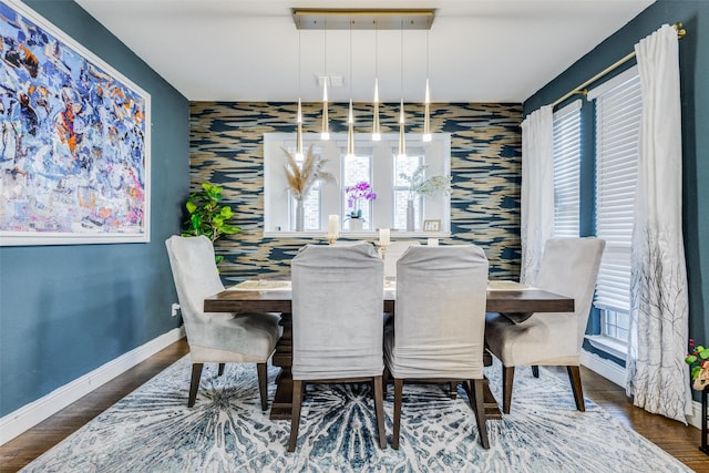 dining room with a wealth of natural light and dark wood-type flooring