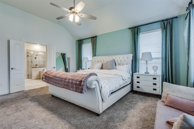 carpeted bedroom with ceiling fan, ensuite bathroom, and vaulted ceiling