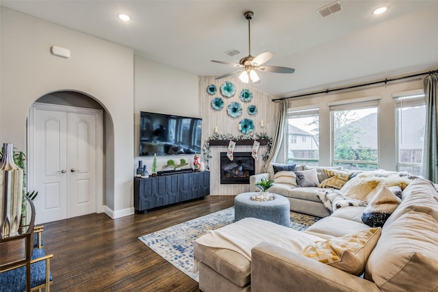 living room with ceiling fan and dark hardwood / wood-style flooring