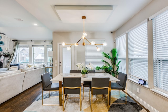 dining room featuring a notable chandelier and dark hardwood / wood-style flooring