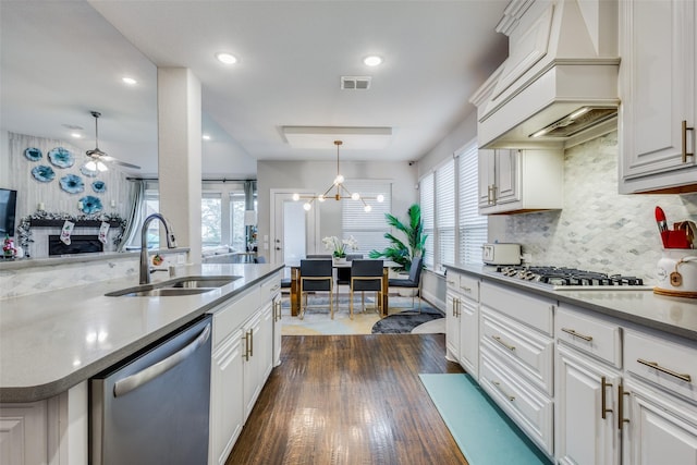 kitchen featuring custom exhaust hood, stainless steel appliances, dark wood-type flooring, sink, and white cabinets