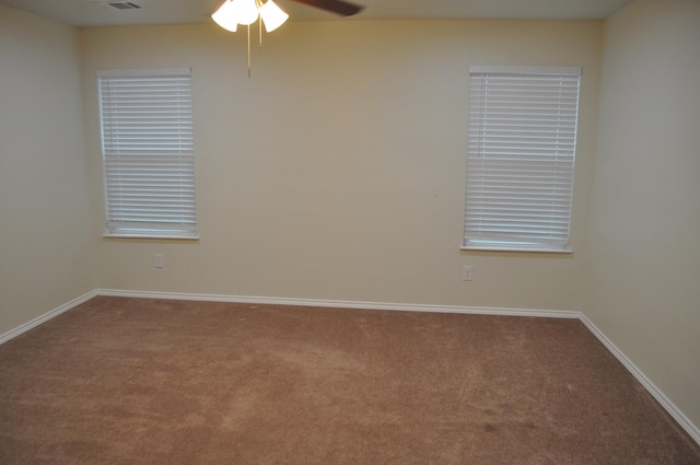 spare room featuring ceiling fan and carpet floors