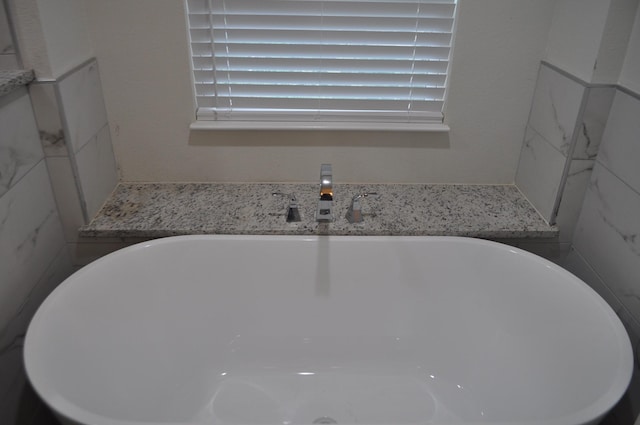 bathroom featuring a bathing tub and sink