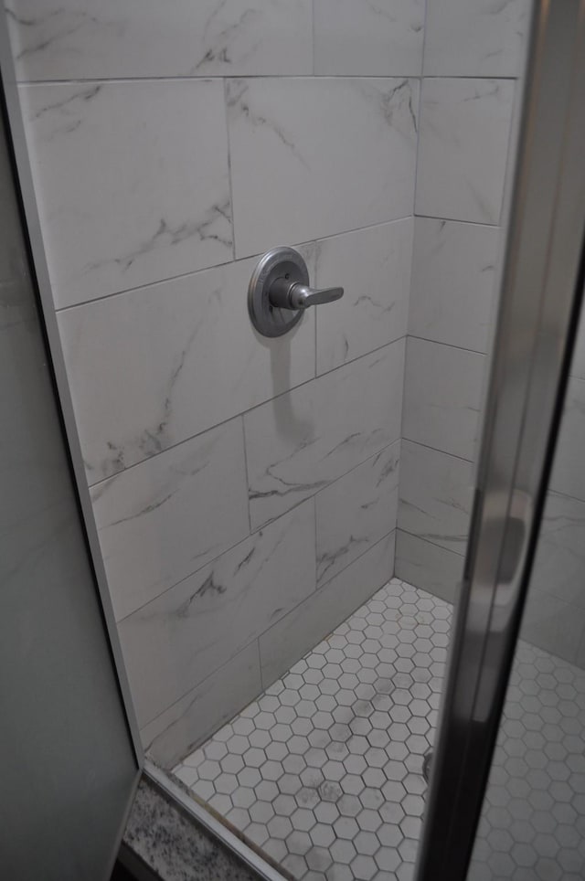 bathroom with a tile shower