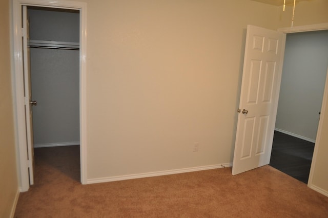 unfurnished bedroom featuring carpet and a closet