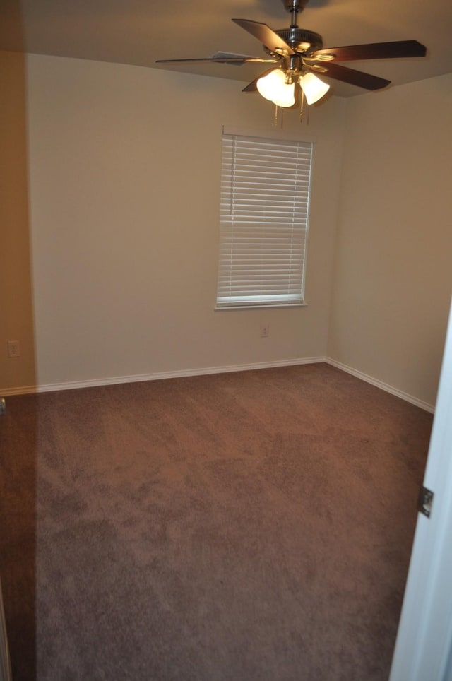 carpeted spare room featuring ceiling fan