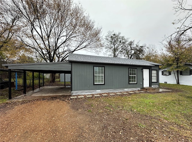 view of front facade with a carport and a front yard