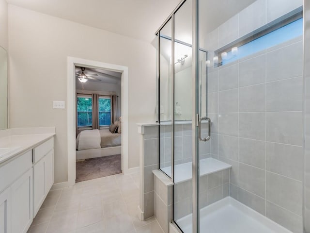 bathroom featuring vanity, ceiling fan, tile patterned flooring, and walk in shower