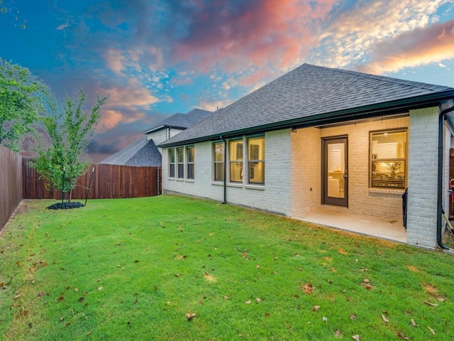 back house at dusk with a yard