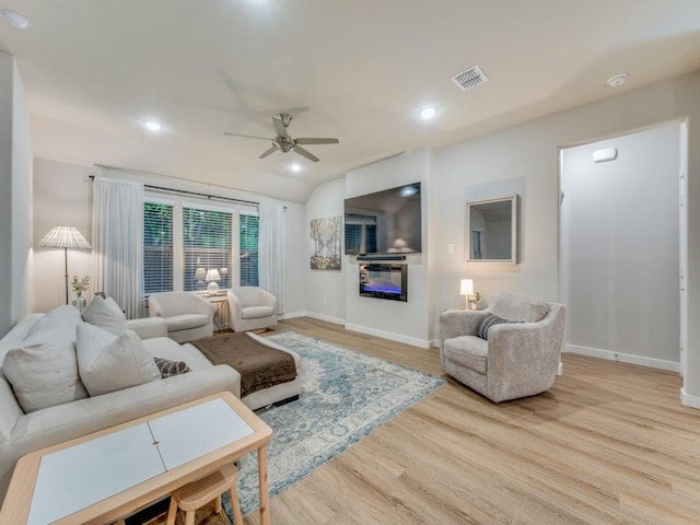 living room with ceiling fan and light hardwood / wood-style floors