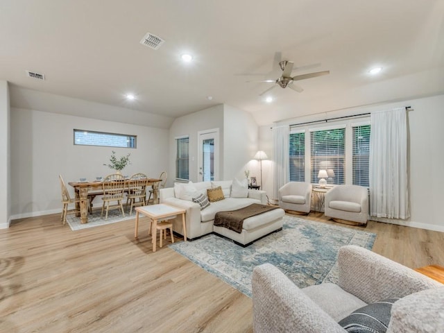 living room featuring light wood-type flooring, ceiling fan, and lofted ceiling