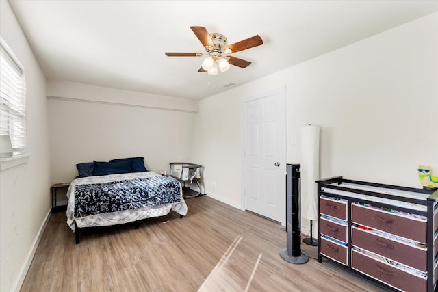 bedroom with ceiling fan and hardwood / wood-style flooring