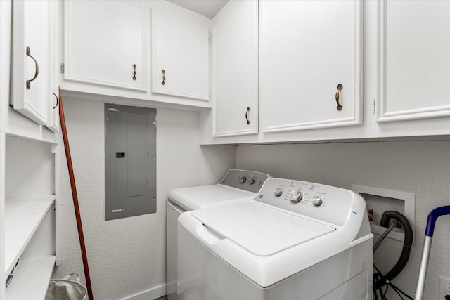 laundry area with cabinets, electric panel, and separate washer and dryer