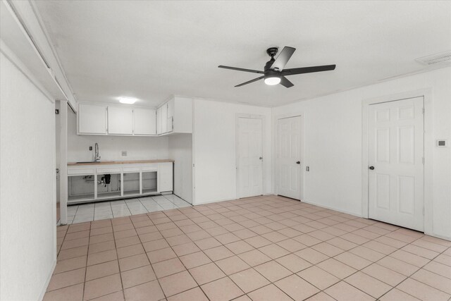 interior space featuring ceiling fan and light tile patterned flooring