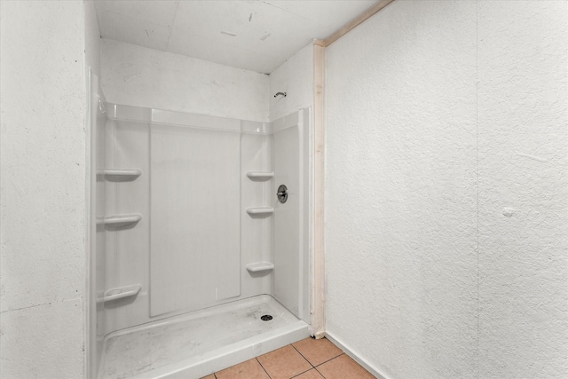 bathroom featuring a shower and tile patterned flooring