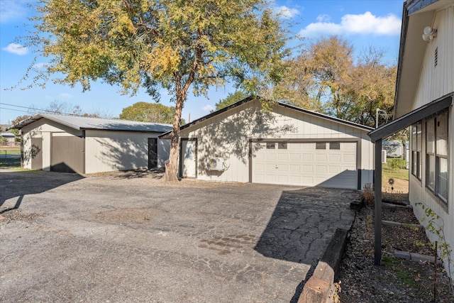 view of side of property featuring an outdoor structure and a garage