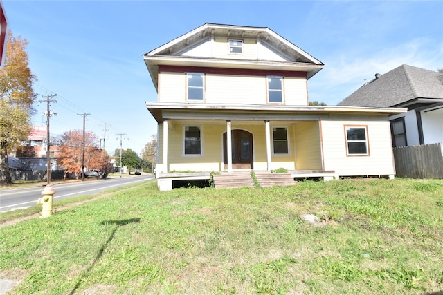 view of front facade featuring a front yard and a porch