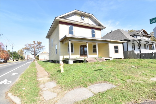 view of front of home with a front lawn and covered porch