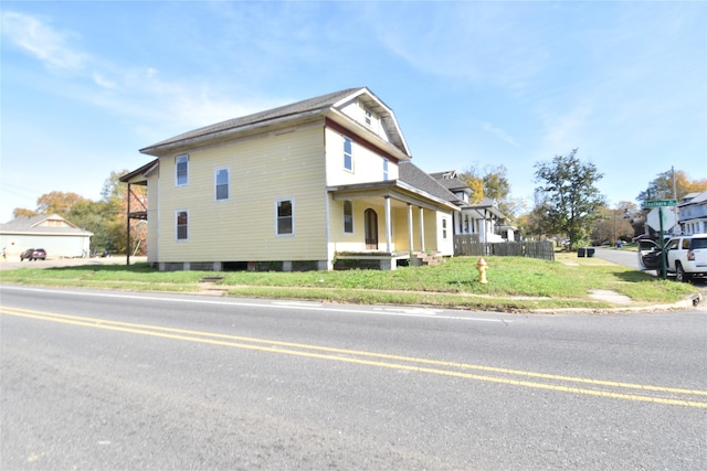 view of home's exterior featuring a yard and a porch