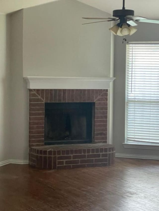 room details with a fireplace, hardwood / wood-style flooring, and ceiling fan