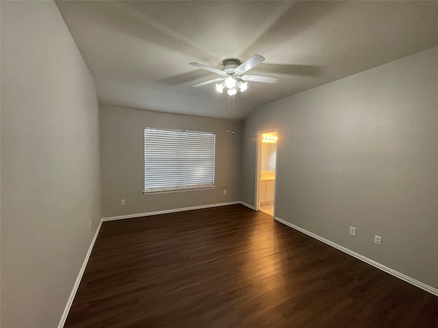 spare room featuring dark hardwood / wood-style flooring and ceiling fan