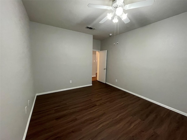 spare room with ceiling fan and dark hardwood / wood-style flooring