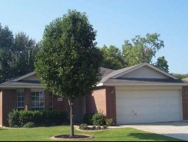 ranch-style house featuring a garage and a front yard