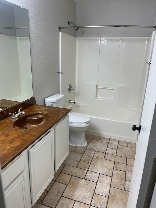 full bathroom featuring bathing tub / shower combination, vanity, and toilet