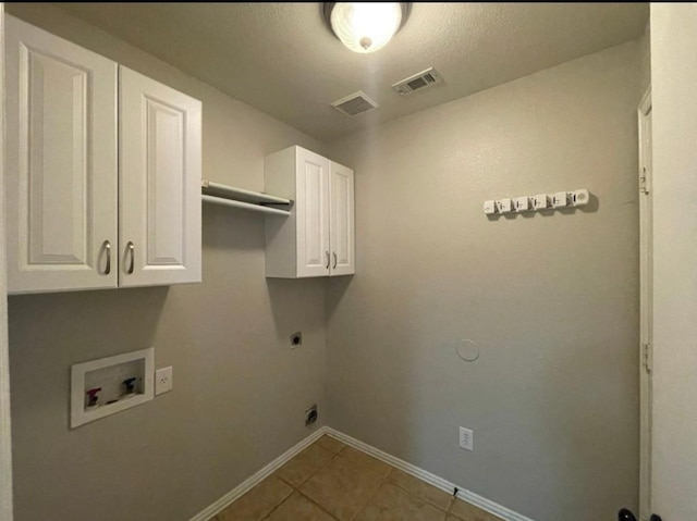 laundry room with tile patterned flooring, electric dryer hookup, cabinets, and hookup for a washing machine