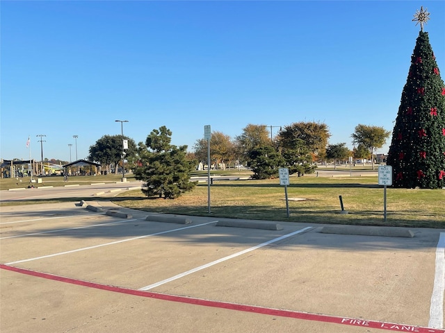 view of vehicle parking featuring a yard