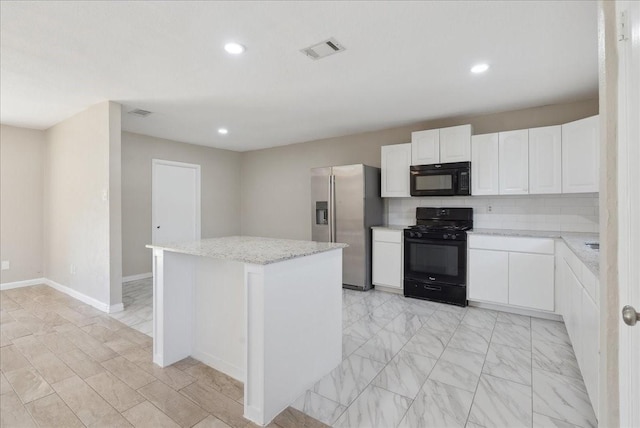 kitchen featuring light stone countertops, a center island, backsplash, white cabinets, and black appliances