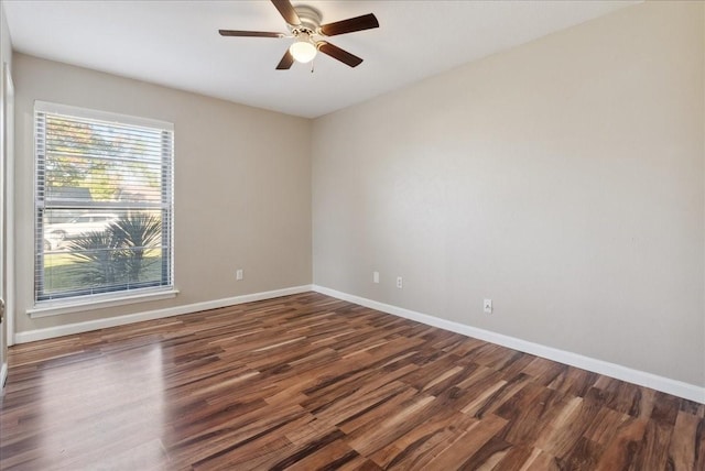 unfurnished room with ceiling fan and dark wood-type flooring