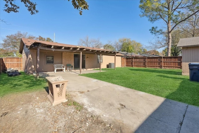 rear view of house with a lawn and a patio area