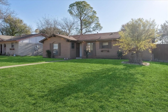 ranch-style home featuring a front yard